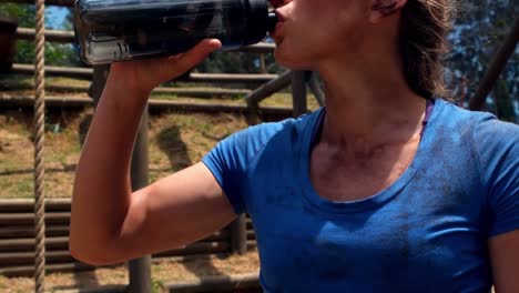 woman drinking water from bottle