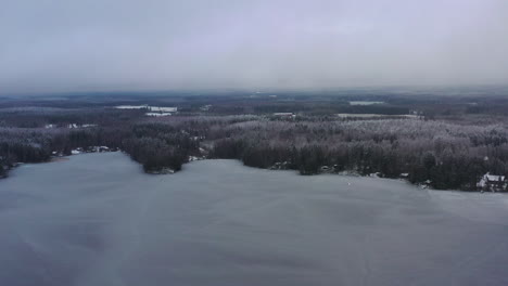 flying over frozen lake in ice cold winter