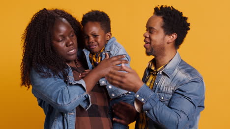 Smiling-loving-young-family-with-a-small-cute-toddler-blowing-air-kisses