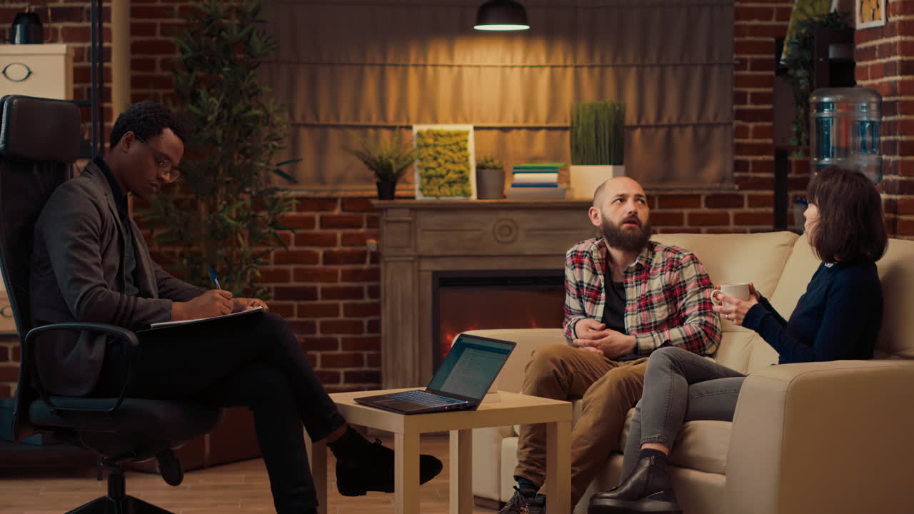 Displeased couple attending counseling session with therapist