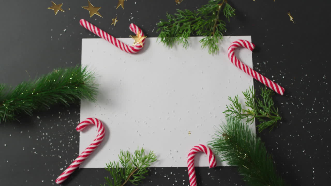 Christmas decorations with candy canes and greenery over festive animation background