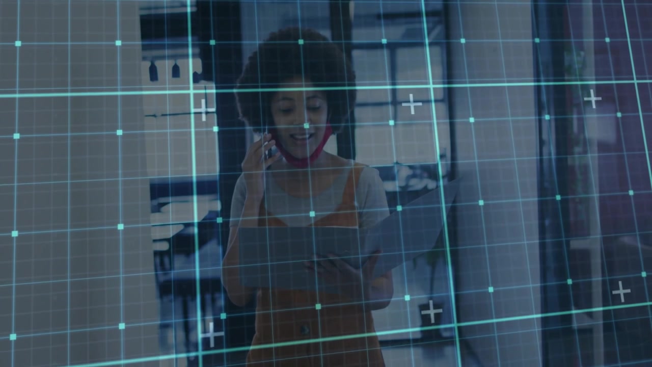 Woman taking call using tablet in office behind glass, adjusting mask, grid overlaying, confirming