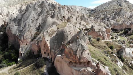 drone flies down while gimbal goes up revealing the ancient city of zelve landscape - kapadokya