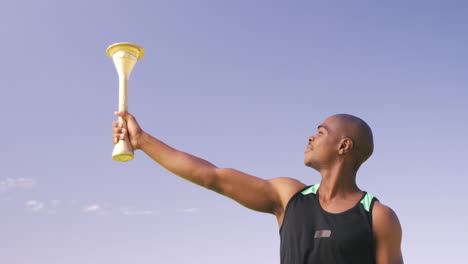 sportsman with olympic torch