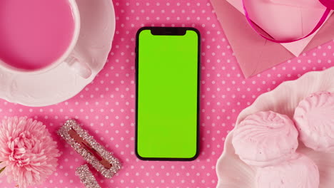 pink aesthetic mockup with green screen phone, teacup and marshmallows
