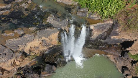 aerial view of a waterfall in a lush forest