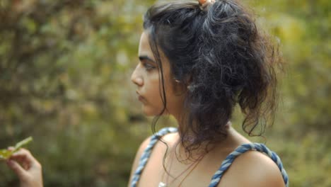 Cinematic-slow-motion-closeup-shot-of-a-model-touching-a-plant-in-the-tropical-rain-forest-of-Goa,-India-with-Black-hair,-Slomo