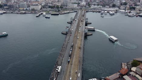 aerial drone footage of beautiful galata bridge in istanbul with, bosphorus, ships and ferries in the background