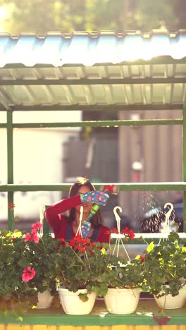 woman watering plants at a flower market