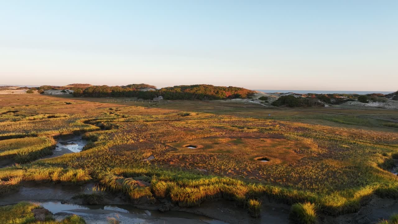 Salt marsh and sand dunes at sunrise at Cape Cod bay, Barnstable, Massachusetts, USA