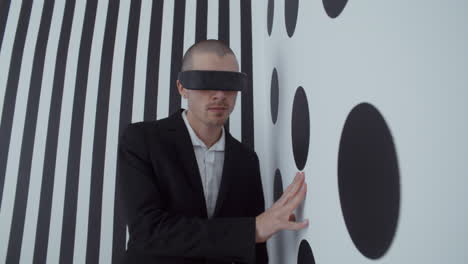 blindfolded man in black and white studio setting