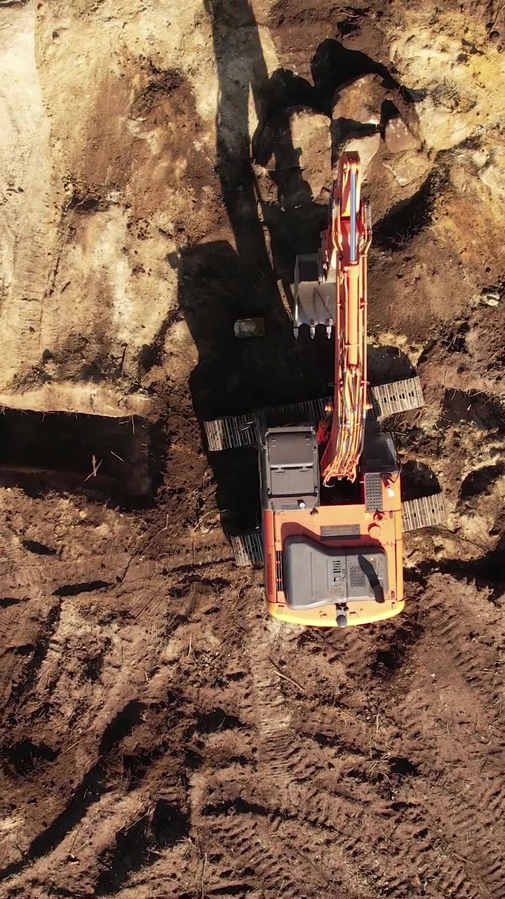 Excavator operating on a hillside