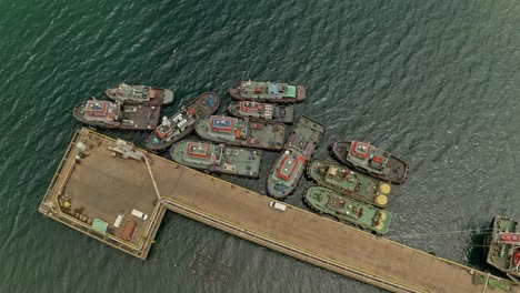 A-group-of-tugboats-docked-next-to-a-concrete-pier-at-nickel-Mines-in-Taganito,-Philippines