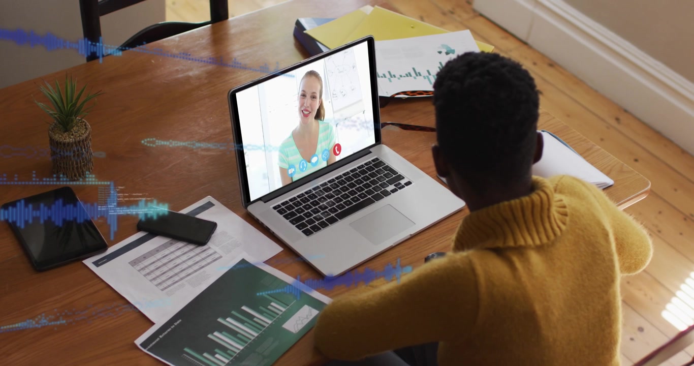 Animation of data processing over african american woman having a video call on laptop at home