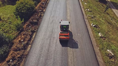large road-roller paving a road. road construction. aerial view.