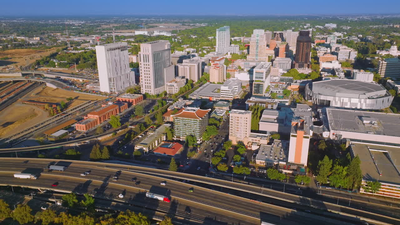 Lively traffic of Sacramento, California, USA. Drone approaching the beautiful downtown with fine architecture on sunny day.