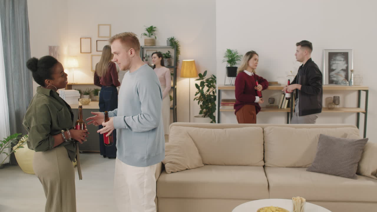 Young People Chatting at House Party