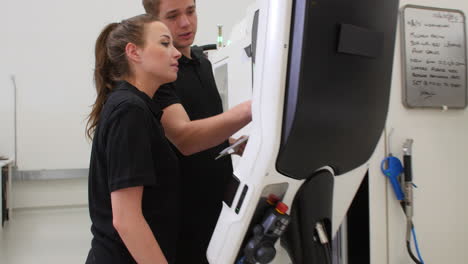 engineers operating cnc machines in factory