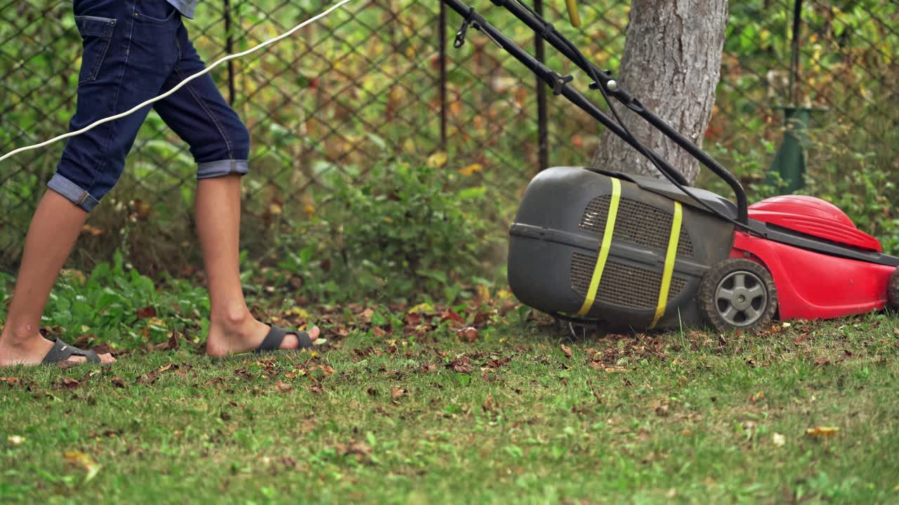Man with lawn mower. Close up view of mower cutting the grass
