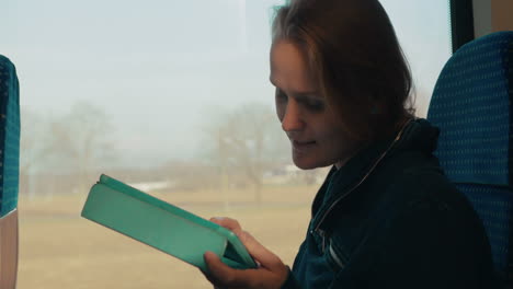 Woman-chatting-on-tablet-PC-in-train