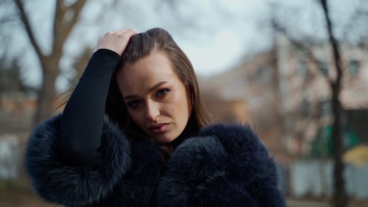 Portrait of young woman in park. Fashion portrait of stylish model woman in park