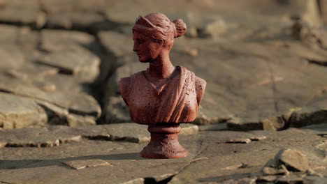 ancient statue of woman on rocky stones