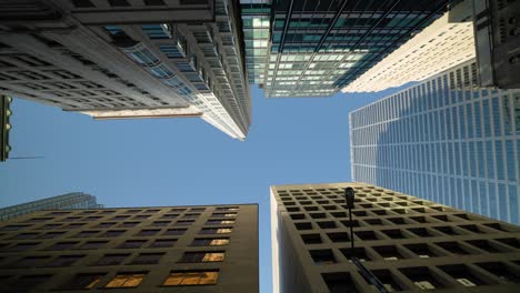 looking up at tall modern architecture office buildings in downtown toronto financial district
