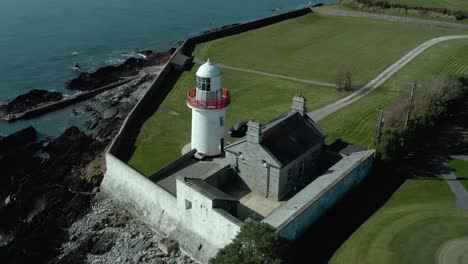 birds eye view orbit shot of light house near sea at day in summer