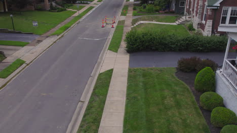 rise from green grass and a sidewalk and street up to an overhead view of a suburban neighborhood in st