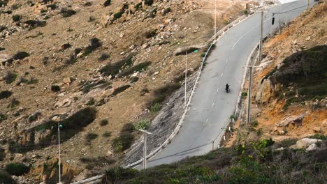 Motorbikes-on-provincial-road-through-rocky-mountainous-landscape-in-Vietnam