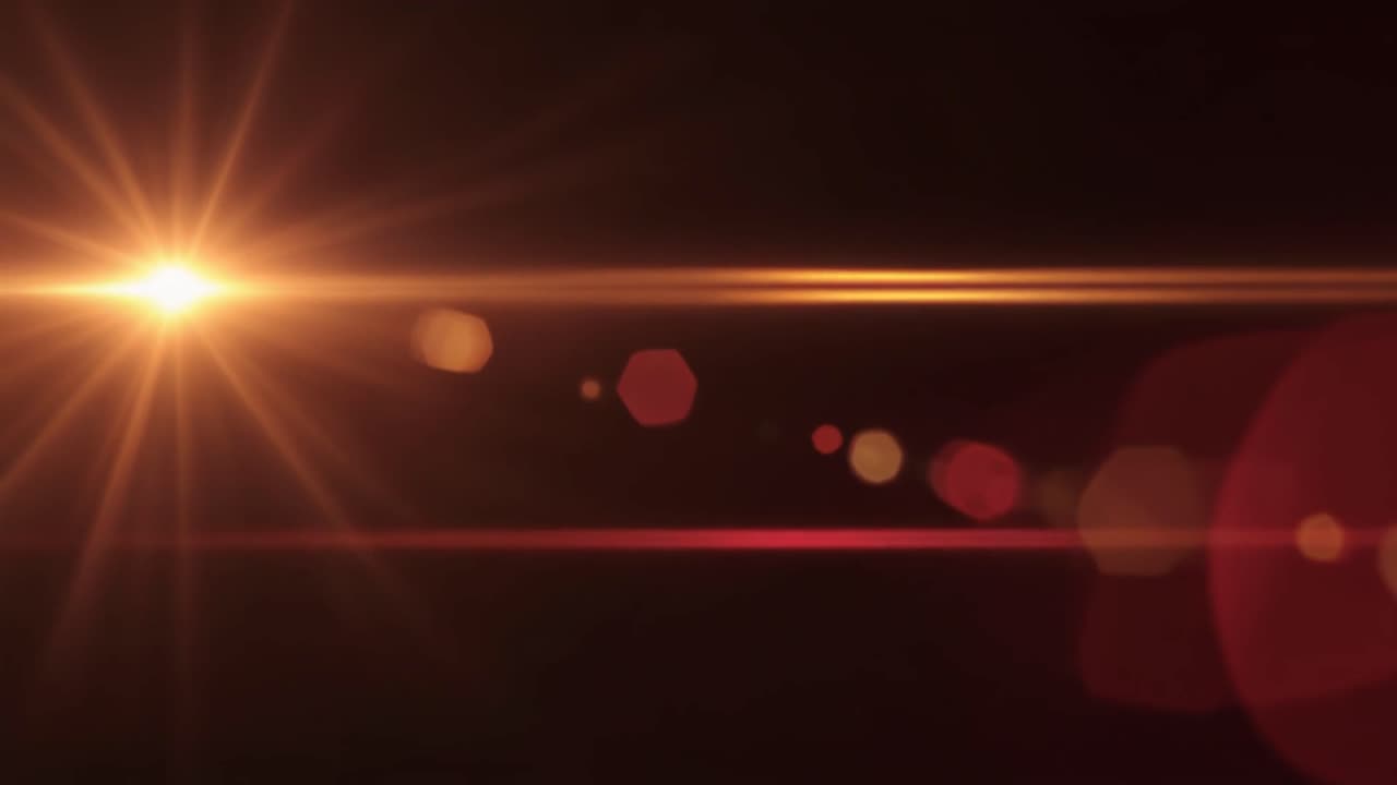 Luminoso bagliore dell'obiettivo arancione e rosso su sfondo nero