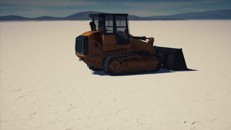 road grading machine on the salt desert road