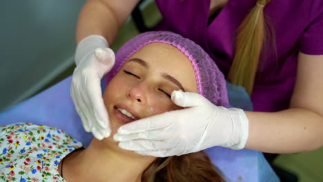 young girl is receiving a facial massage and spa treatment for a perfect skin in a luxury wellness center.