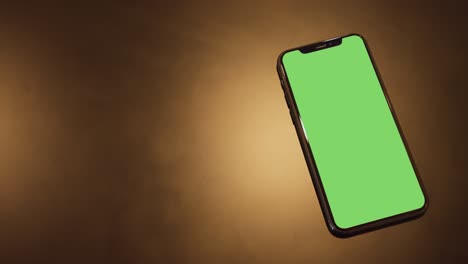 smartphone place on black background with gold ligh