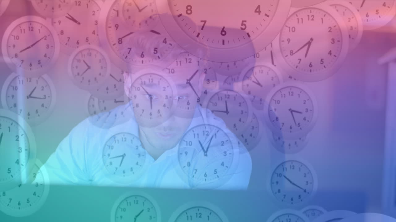Working on computer in office, man with clocks animation in background