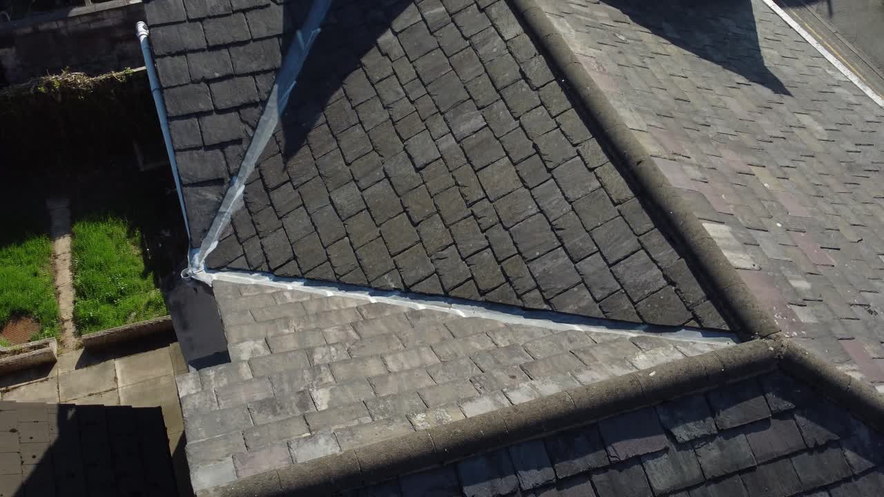 Rooftop inspection aerial view inspecting overlooking damage and repair of real estate for homeowner