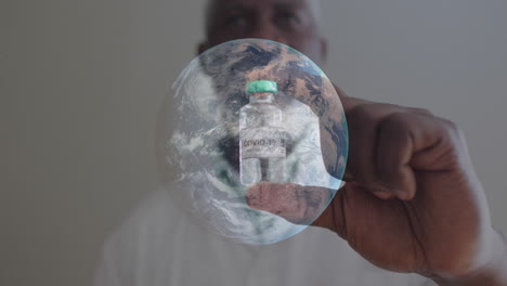 spinning globe against portrait of male african american man holding covi-19 vaccine