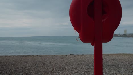 static slow motion shot of a life preserver on a beach in southsea