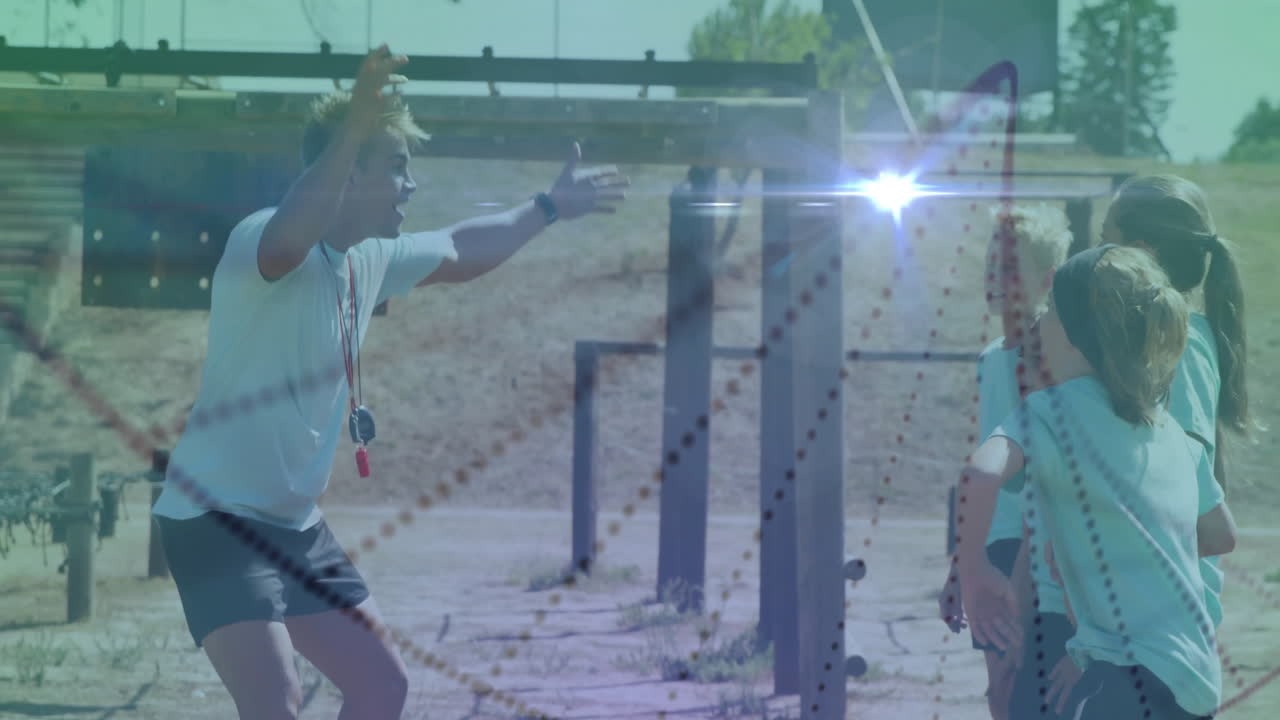 On outdoor training field, coach greeting young athletes with enthusiasm