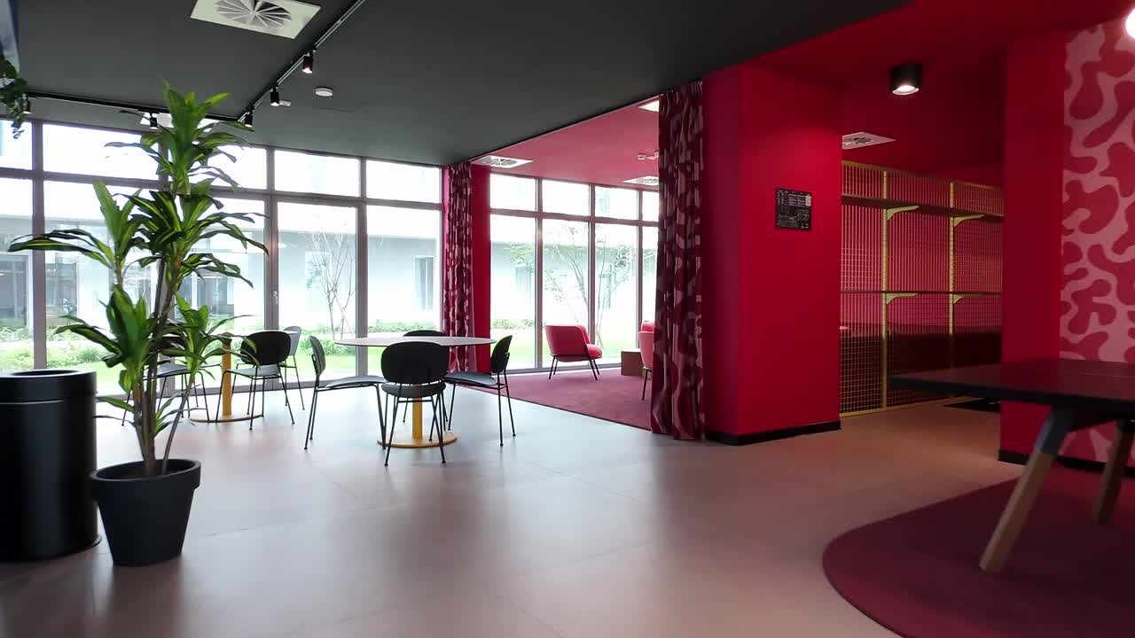 Modern Red and Pink Lounge Area with Large Windows