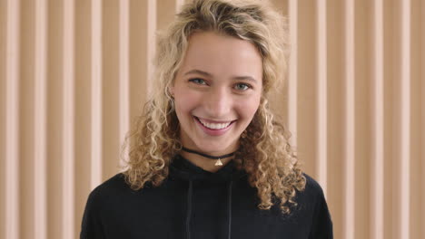 close-up-portrait-of-cute-young-blonde-woman-laughing-cheerful-looking-at-camera-caucasian-female-wearing-black-hoodie