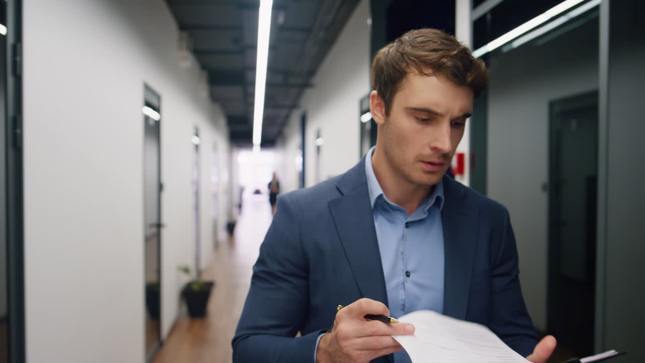 Worried executive checking documents report. Dissatisfied manager walking office