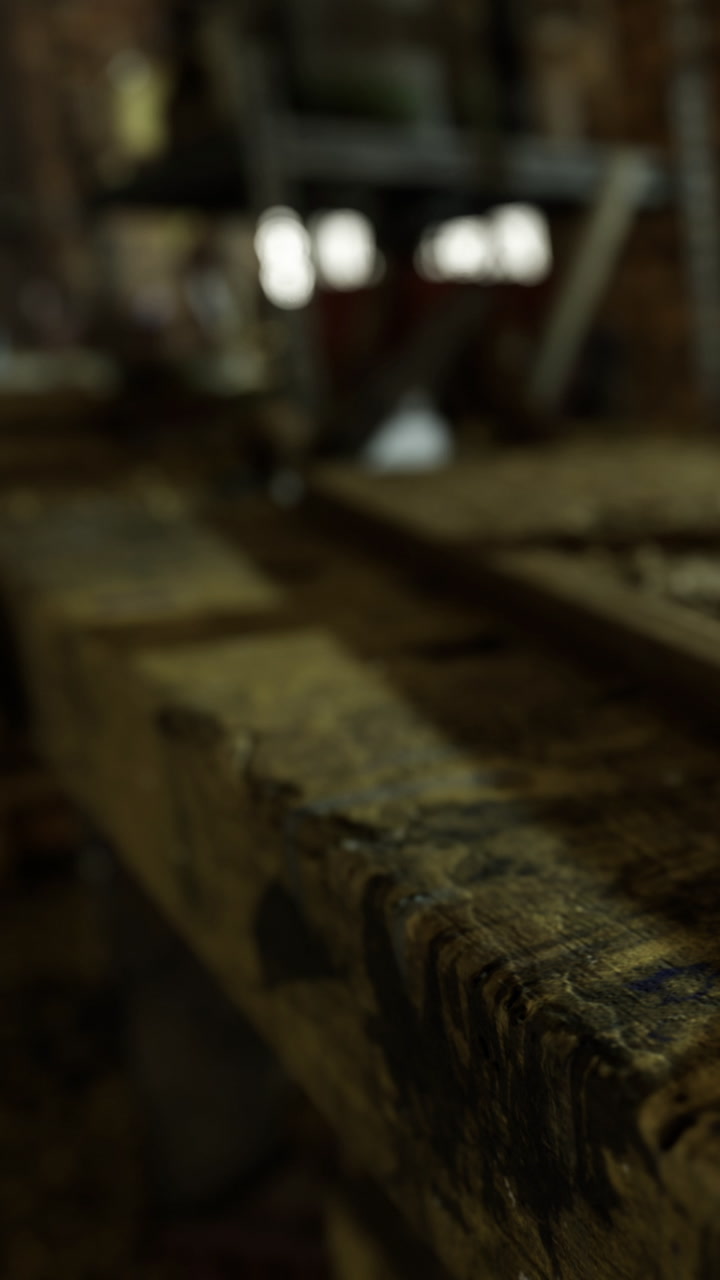 Wooden surface in workshop with tools and equipment in background