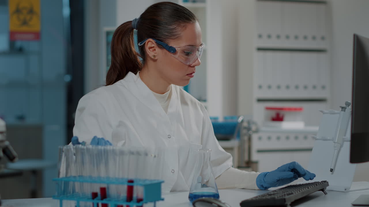 Lab worker using micro pipette with beaker and test tubes