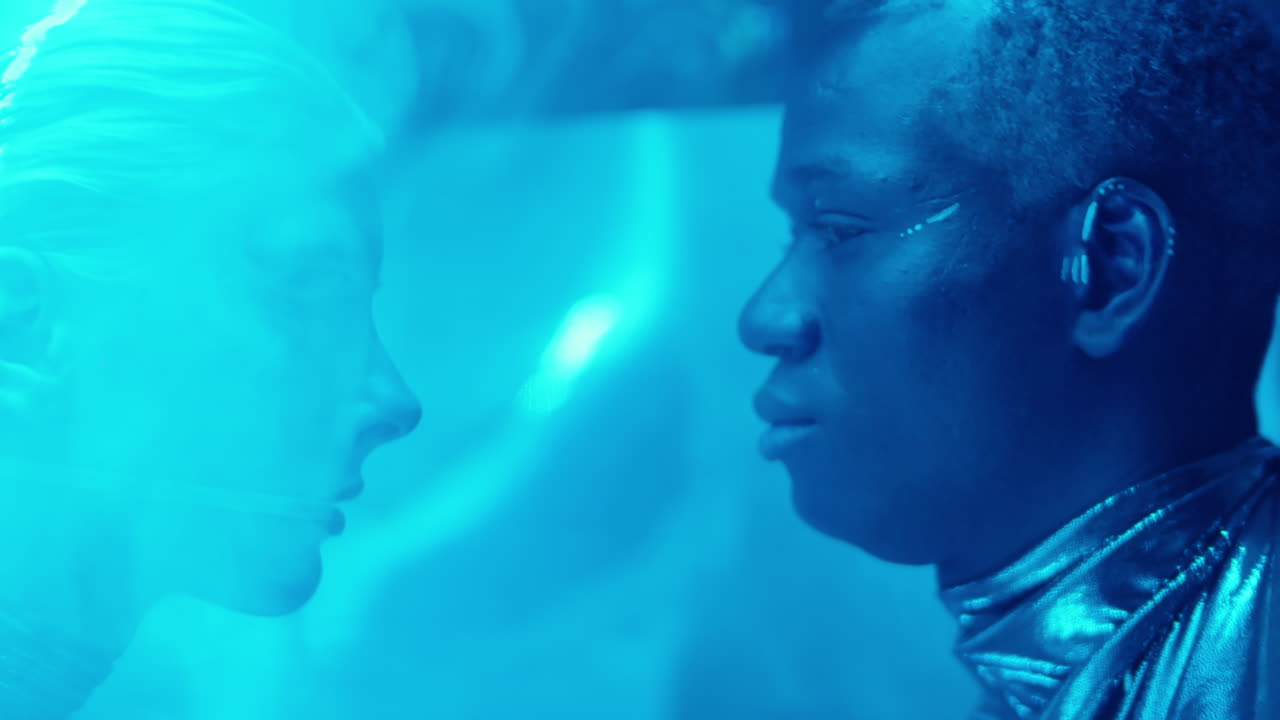 Futuristic Couple in Laser Beams and Blue Neon Light