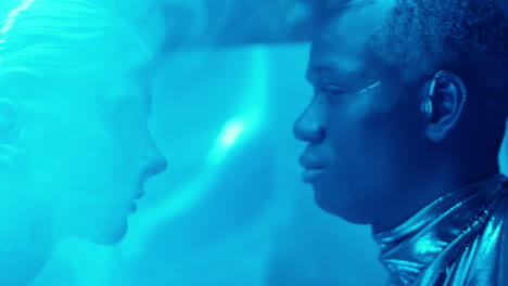 futuristic couple in laser beams and blue neon light