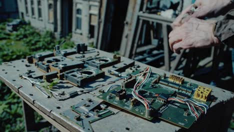 repairing old electronics outdoors