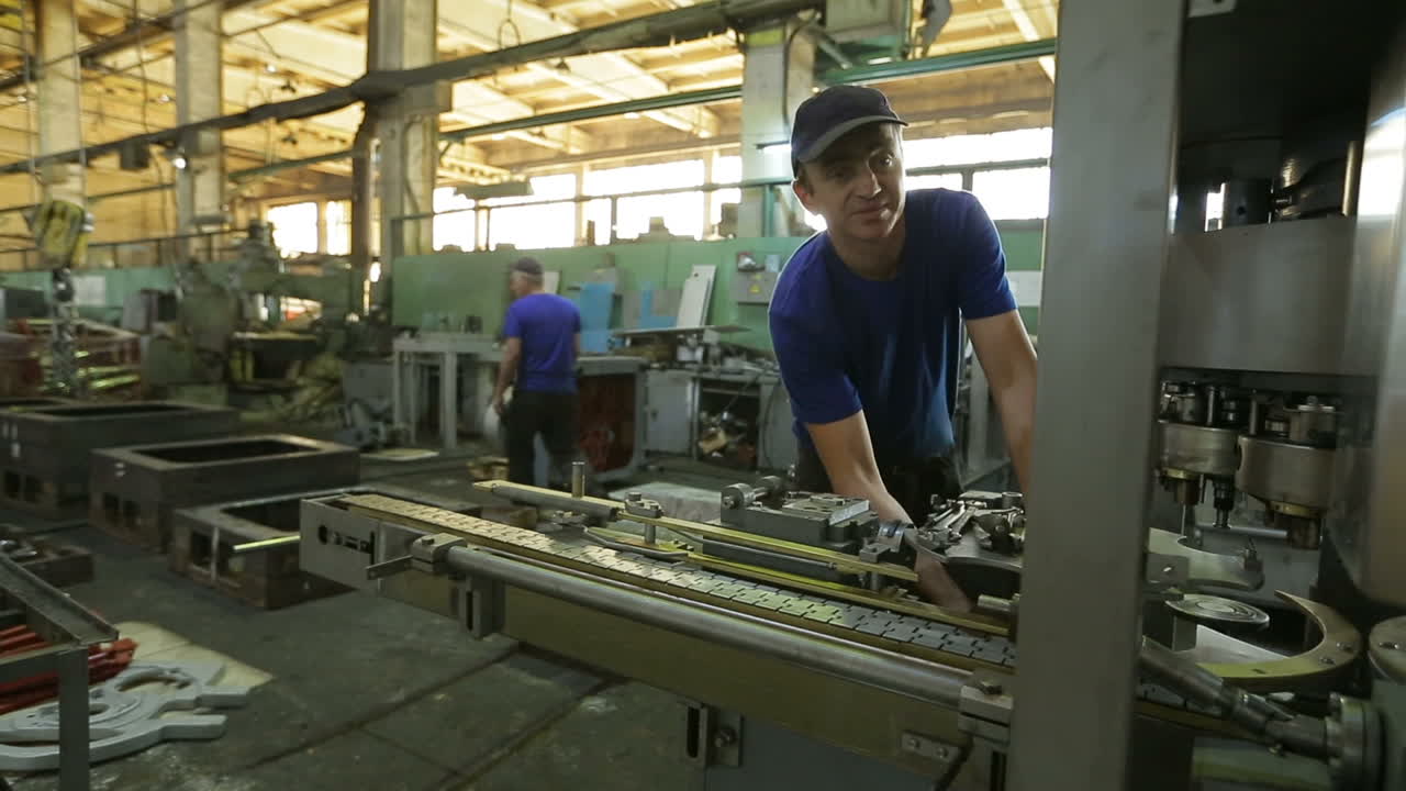Worker At Stockroom In Factory. BAR, UKRAINE - AUGUST 2017: Engineer working on machine in factory
