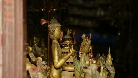 gold buddha statue at buddhist temple in bhaktapur in nepal, close up of golden gold leaf buddhas statues in bhaktapur ancient city unesco world heritage site, religious symbol of buddhism