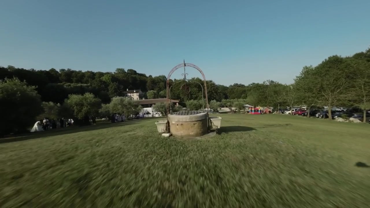 Dynamic FPV drone footage flying directly through the opening of a traditional stone well in the rural Colli Berici near Vicenza, Italy.